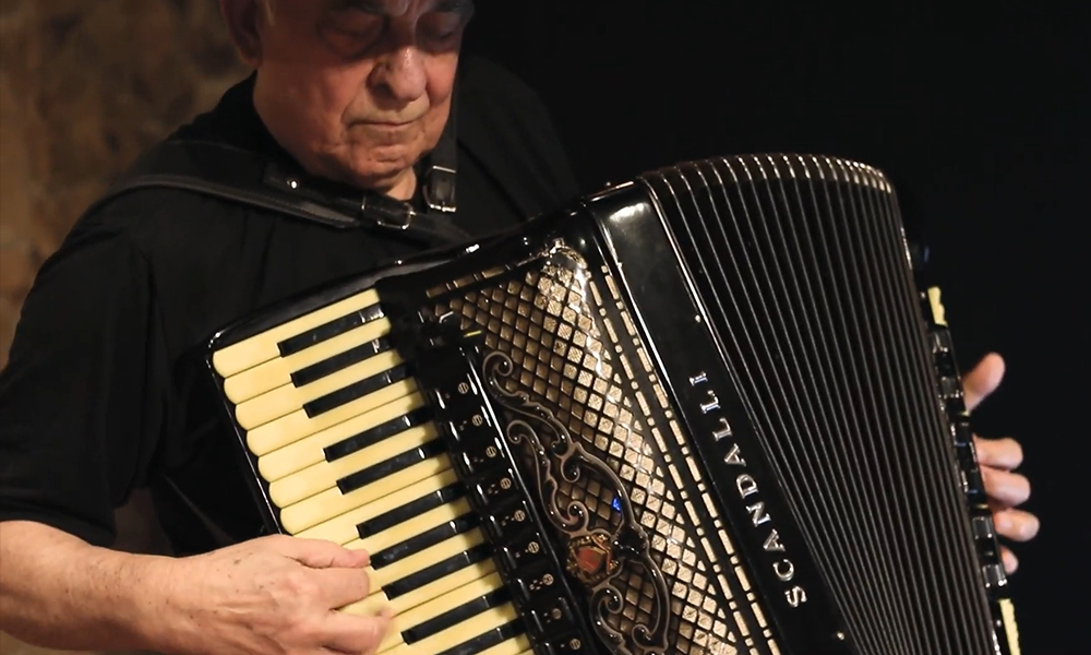 Fotografia ilustrativa de um acordeonista utilizando Oitavador